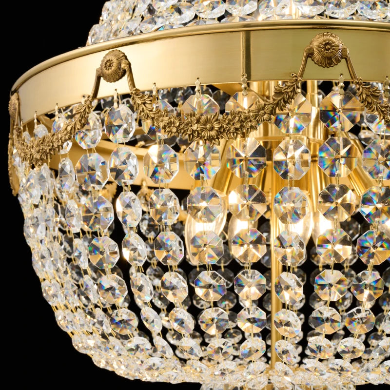 Detailed macro shot of layered crystal bead curtains on a golden brass chandelier frame.