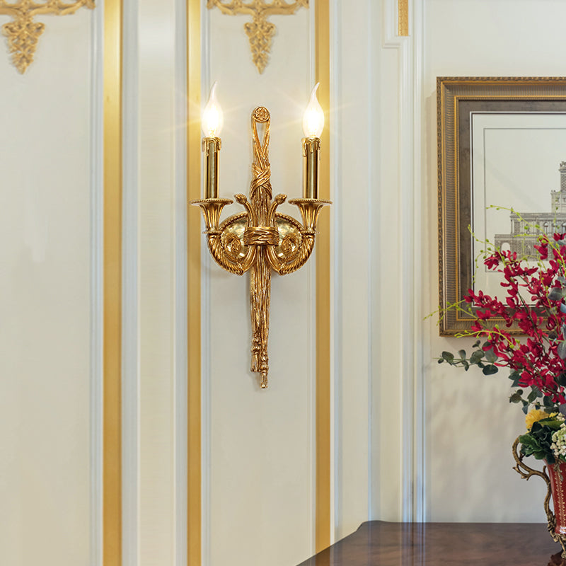 Close-up detail of the central brass column showcasing intricate engraved textures and classic antique finish.