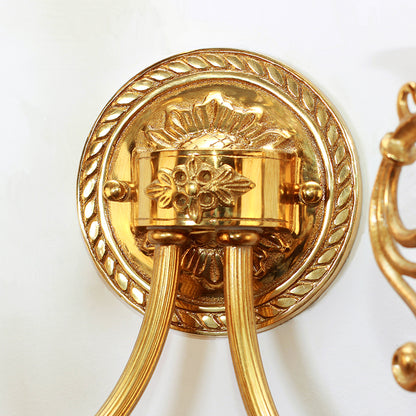 Extreme close-up macro detail of the circular wall mounting plate, featuring a finely engraved floral and wheat-sheaf motif.