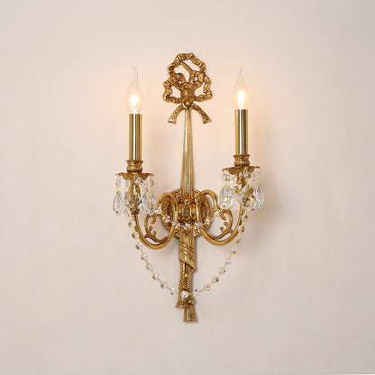 Side view of the home decorative wall sconce with illuminated candle-style bulbs and hanging crystal strands.