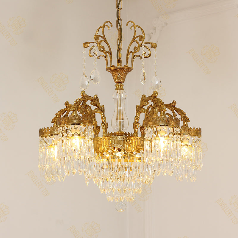 Classic brass chandelier with a central crystal column and side cascades, elegant design.