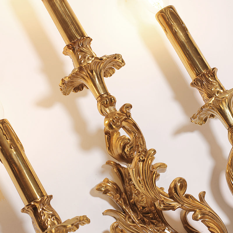 Extreme close-up detail of the sconce’s brass column, showcasing masterful floral and vine engraving techniques.