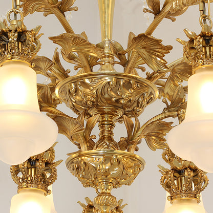Extreme close-up of ornate Baroque-style brass scrollwork and leaf engraving on the chandelier.