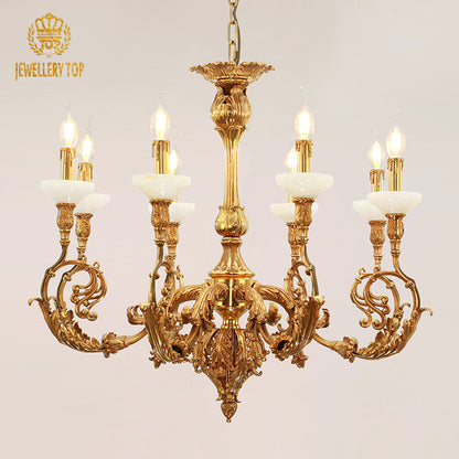 Close-up front view of JEWELLERY TOP's golden brass chandelier with intricate details and lit bulbs.