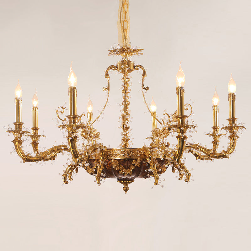 An eight-light brass chandelier with a central column and sparkling crystal pendants on a white background.