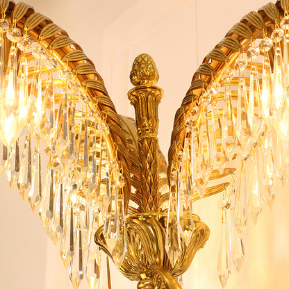 Macro shot of a single, intricately textured brass palm leaf adorned with sparkling clear crystal droplet pendants.