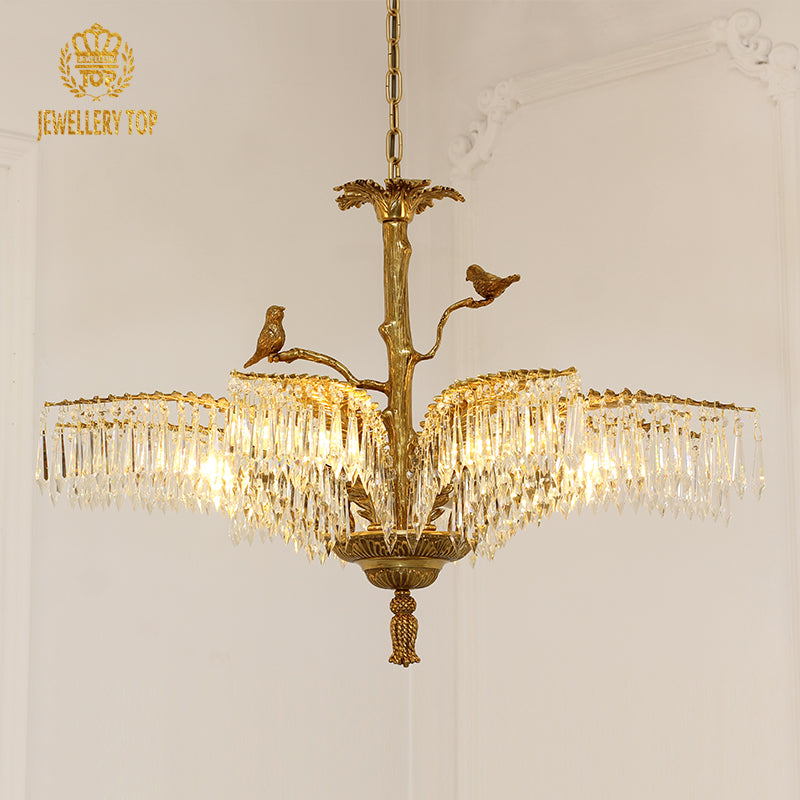 Side profile of Jewellery Top's golden brass chandelier installed on a light wall.