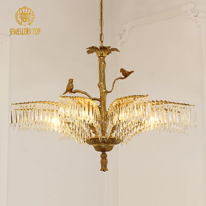 Side profile of Jewellery Top's golden brass chandelier installed on a light wall.