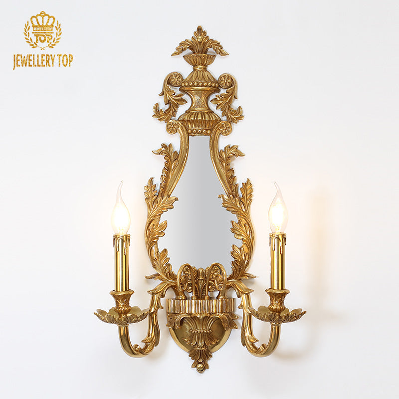 JEWELLERY TOP branded brass wall lamp, showcasing the ornate frame, heart-shaped tracery, and candle bulbs.