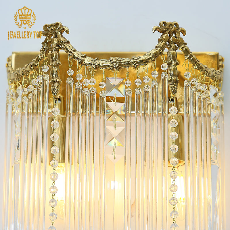 Side angle view of the wall lamp, highlighting the depth of the crystal curtain and the warm glow from the light columns.