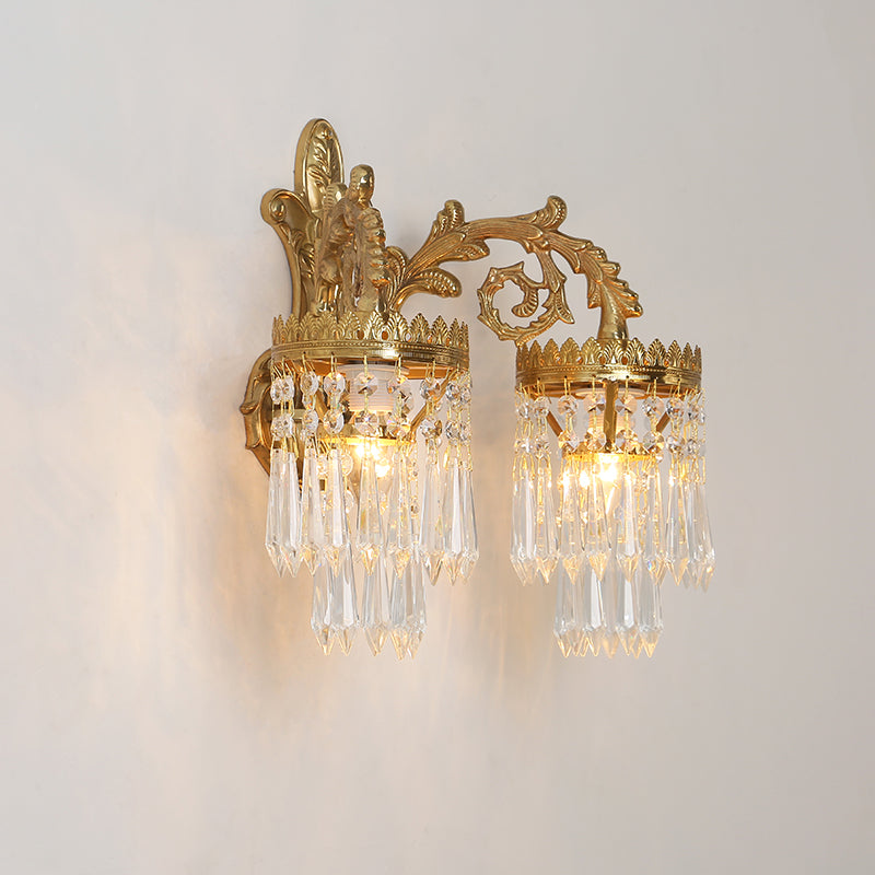 Detailed macro shot of the sconce’s intricate scrollwork, leaf carvings, and polished brass finish.