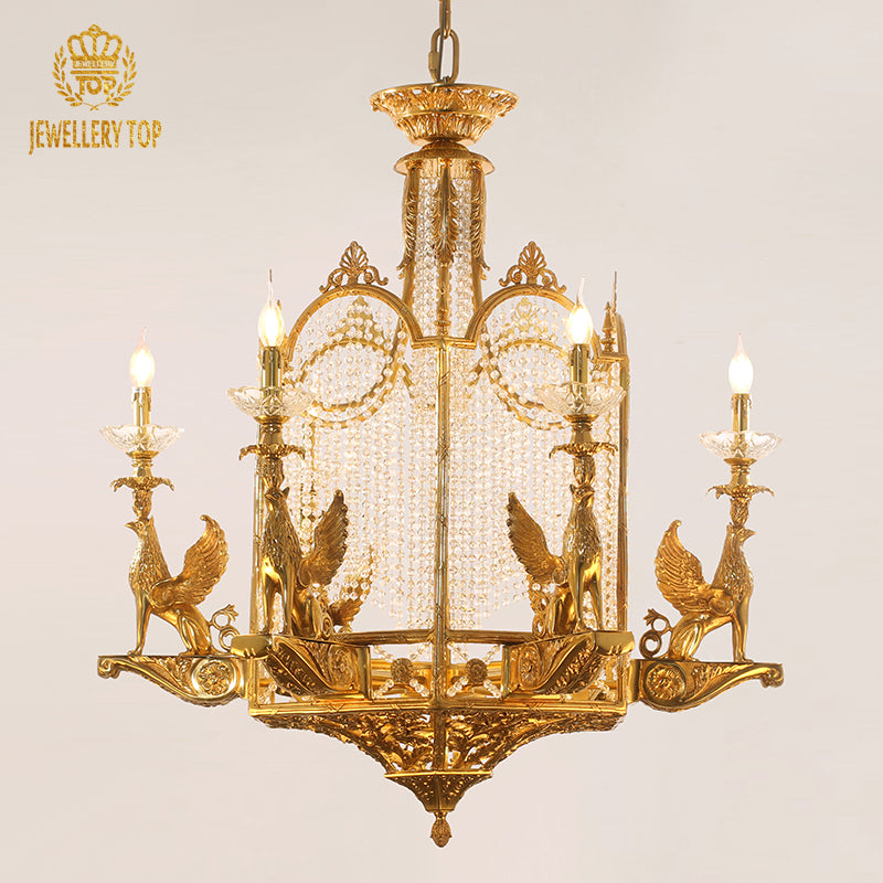 A royal palace chandelier installed in a grand two-story foyer with ornate crown molding and a sweeping staircase.
