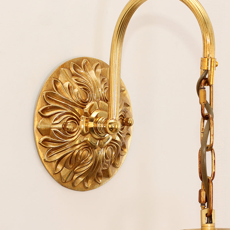 The brass sconce mounted as a pair beside a mirror, demonstrating its perfect scale for bedroom or vanity use.