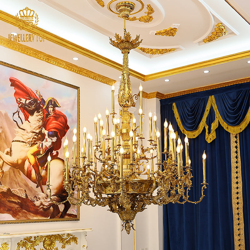 Jewellery Top brand's luxury brass chandelier in an interior with navy curtains and painting.