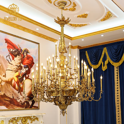 Jewellery Top brand's luxury brass chandelier in an interior with navy curtains and painting.