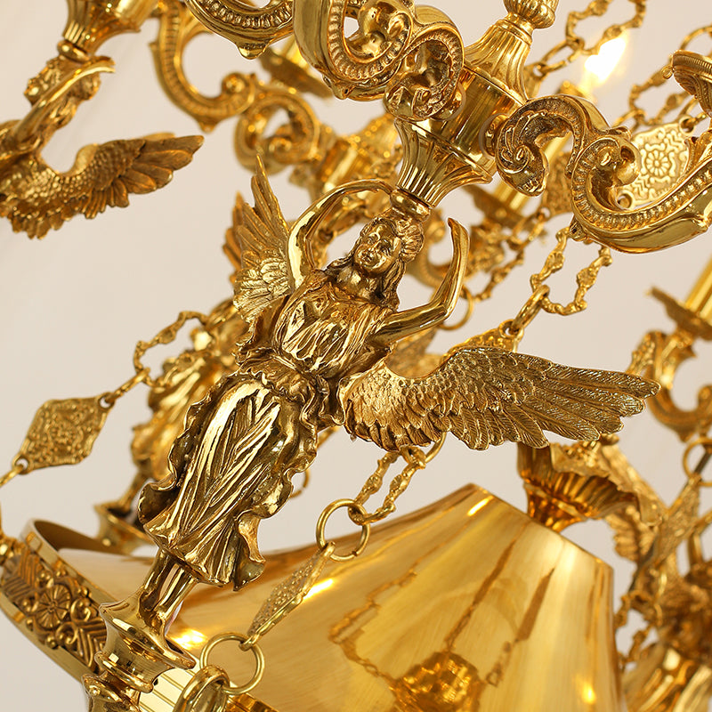 Macro close-up of the finely detailed golden angelic figure with spread wings and the precision-cut crystal prisms.