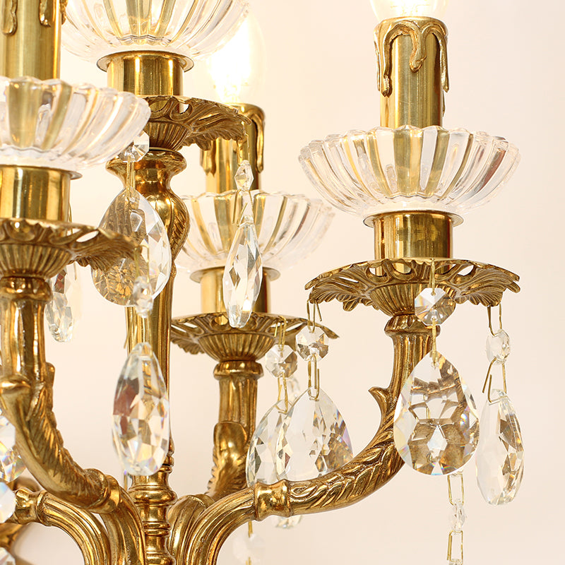 Macro detail of the hand-chased brass scrollwork and the sparkling teardrop crystal ornaments.