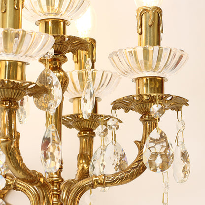 Macro detail of the hand-chased brass scrollwork and the sparkling teardrop crystal ornaments.