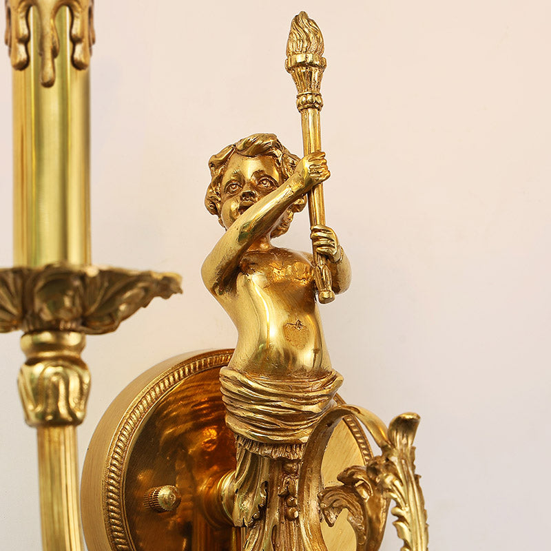 Macro extreme close-up of the cherub sculpture holding a torch, highlighting the intricate golden brass details and texture.
