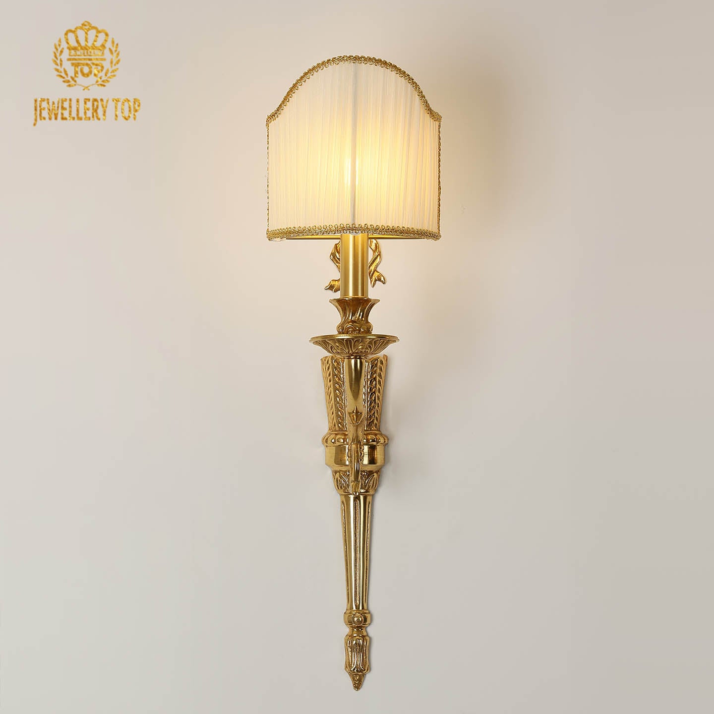 JEWELLERY TOP Noeud de Soie Brass Wall Sconce with a detailed golden bow and white fabric shade on a light wall.