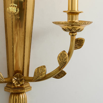 Close-up shot of hand-carved solid brass laurel leaves and rosette on the George III Girandole sconce by Jewellery Top.