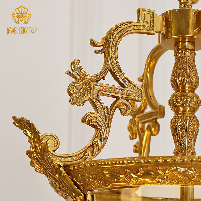 Macro detail of ornate brass and brand logo on the French vintage pendant light.