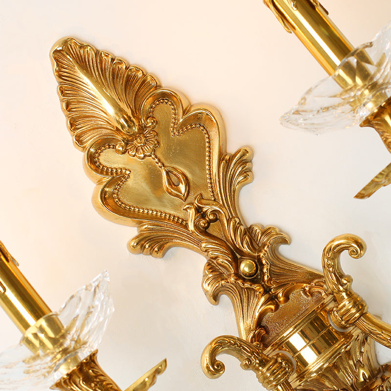 Extreme macro detail of the sconce’s Baroque-style openwork backplate, showcasing feather-like leaf carvings.