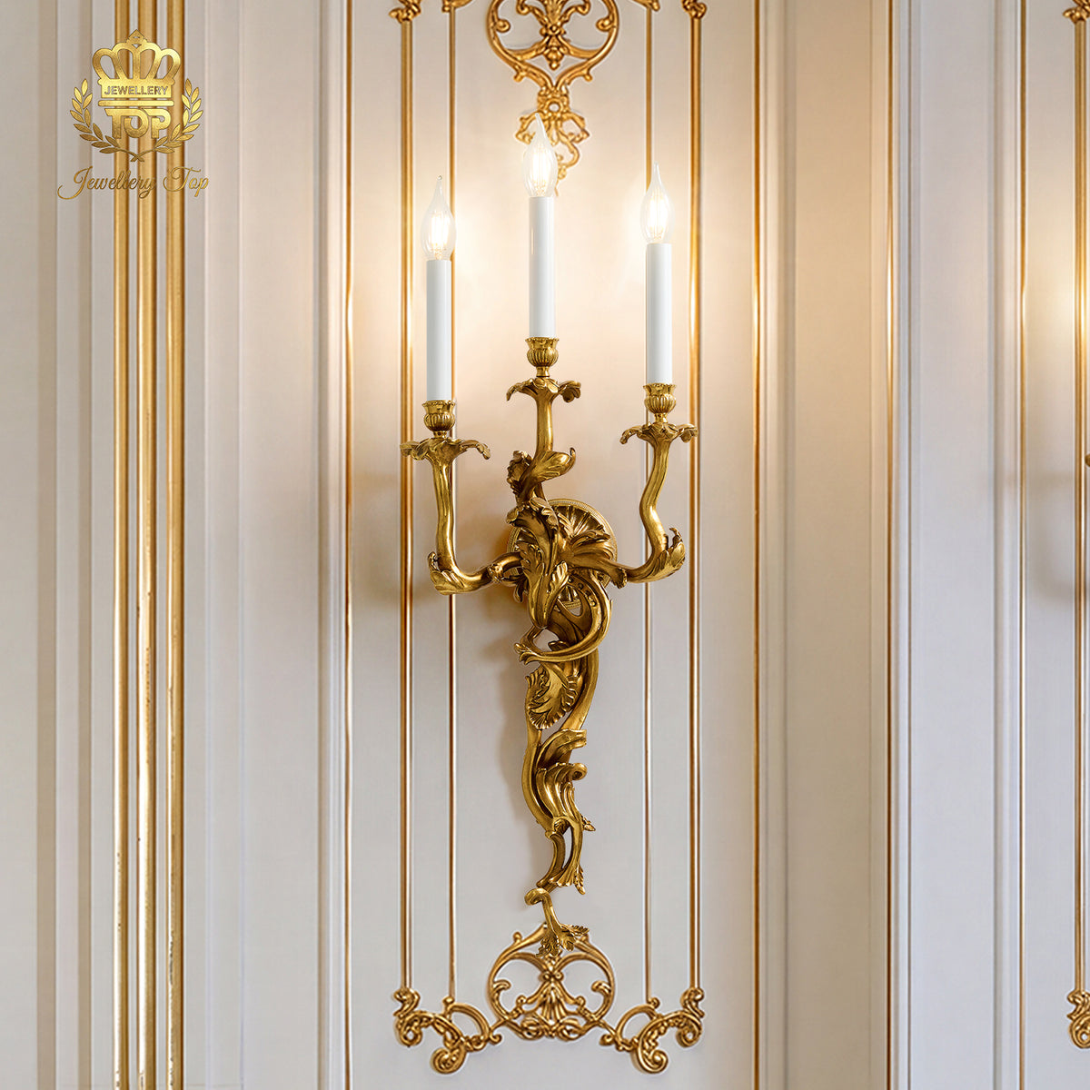 Lifestyle shot of the gold Chloris sconce mounted on an ornate French panel wall with gold leaf molding.