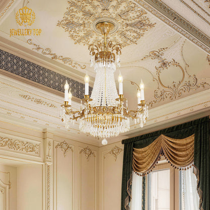 French luxury brass chandelier installed in a room with gold-accented ceiling and green curtains.