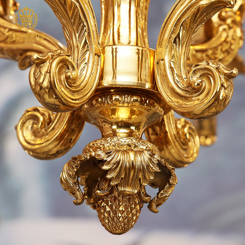 Detailed close-up of a textured brass pineapple decoration on the French home decorative chandelier.