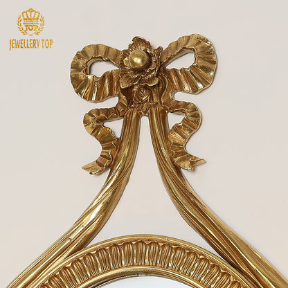 Detailed view of the curved candle arm and lit bulb, emphasizing the luxurious metal craftsmanship of the hotel wall lamp.