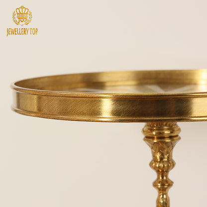 Detail shot of the polished brass rim edge and upper stem of The Chrysomallos table by Jewellery Top.