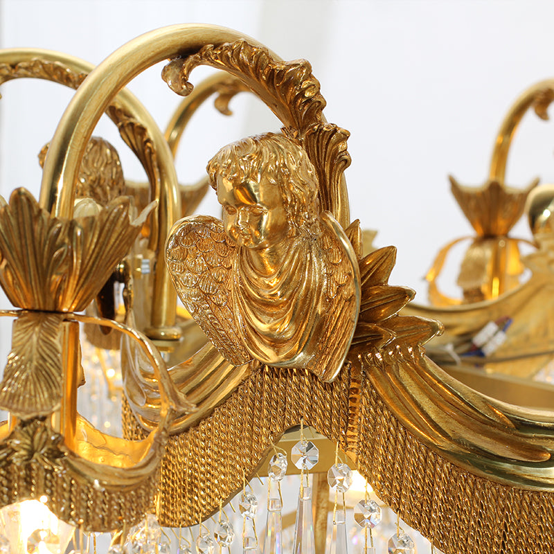 Macro close-up of the finely sculpted angel figure amidst scrolling brass foliage.