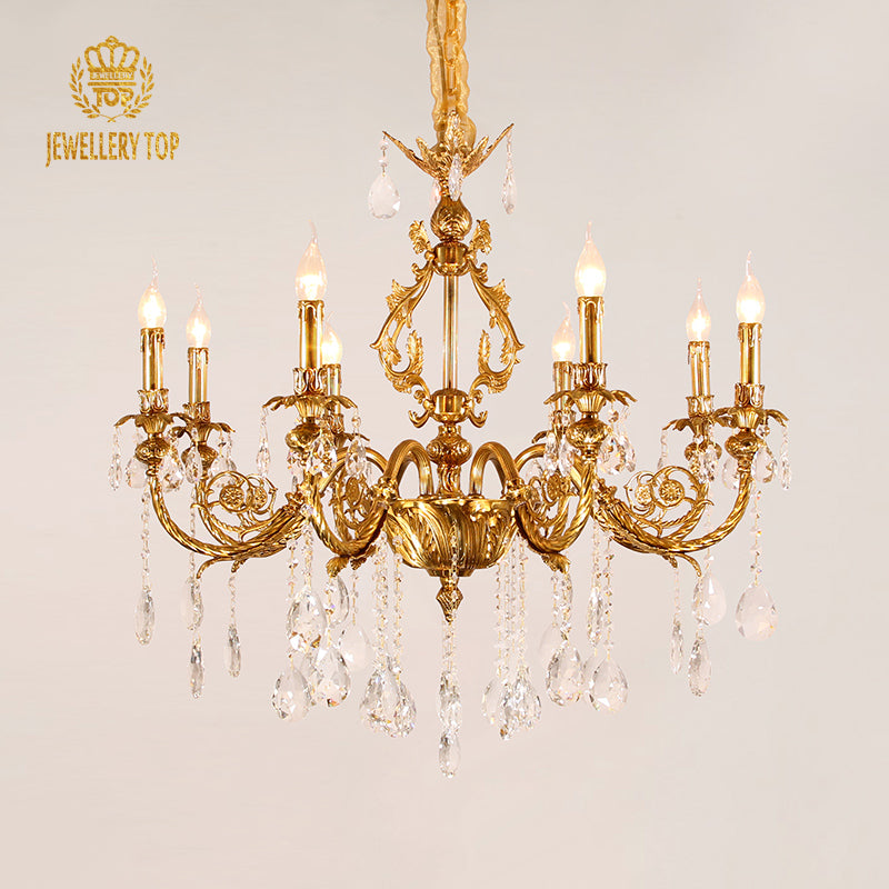 Extreme detail shot of the ornate solid brass acanthus leaf arm and crystal connection.