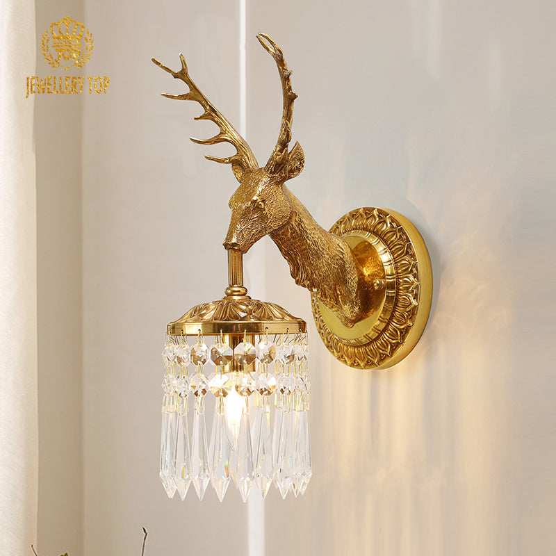 Side view of the creative stag head wall lamp mounted on patterned wallpaper, with decorative branches in the foreground.