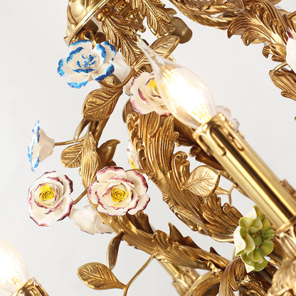 Macro close-up of hand-painted ceramic roses and leaves on a French brass chandelier arm.