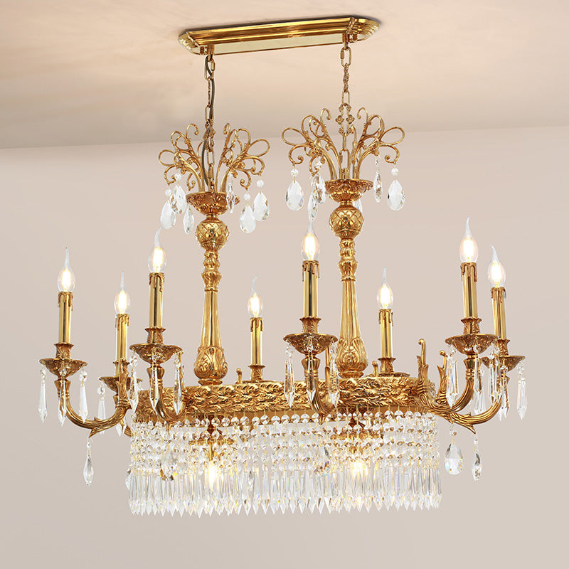 Detailed side view of the brass chandelier’s candle bulbs and hanging crystal decorations.