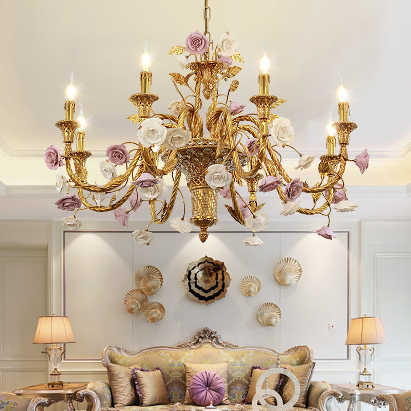 The brass and ceramic chandelier installed in an elegant living room with shell-decorated wall.