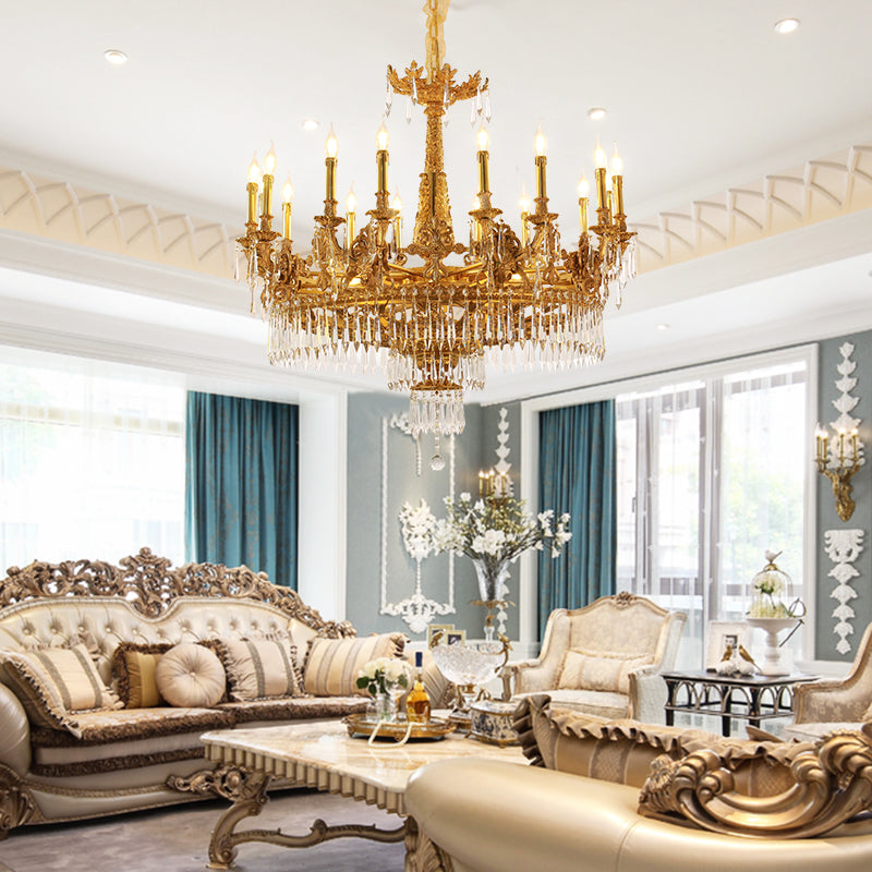 A luxurious vintage brass chandelier illuminating an opulent French-style living room interior.