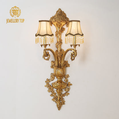 JEWELLERY TOP branded golden luxury wall sconce with crystal fringe, isolated on a white background.