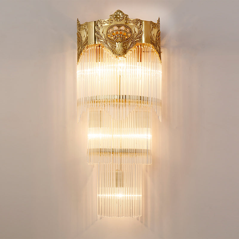 Close-up detail of the sconce’s intricate brass scrollwork and the hanging crystal curtain.
