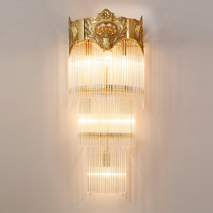 Close-up detail of the sconce’s intricate brass scrollwork and the hanging crystal curtain.
