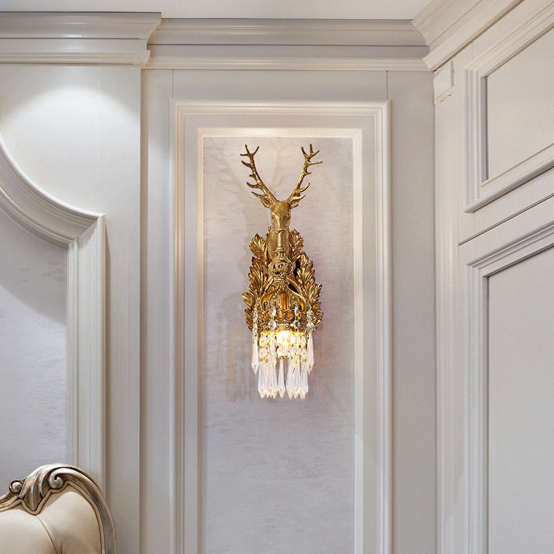 The French wall sconce installed on a light wall with white molding, showcasing its warm, elegant glow.