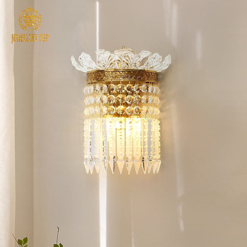 Front view of the JEWELLERY TOP brass wall sconce showcasing intricate scrollwork and cascading crystal strands.