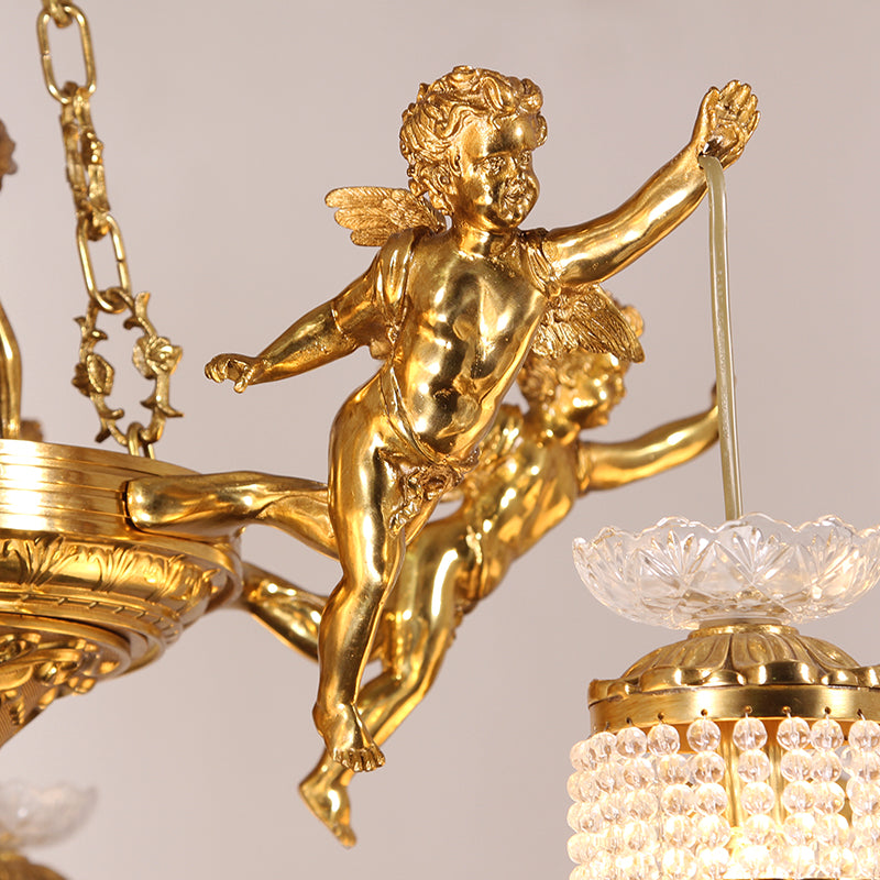 Extreme close-up of a single smiling angel statue and a crystal beaded shade on the chandelier.