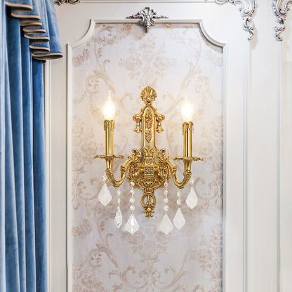 A pair of European castle-style brass wall lamps installed on elegant wallpaper.