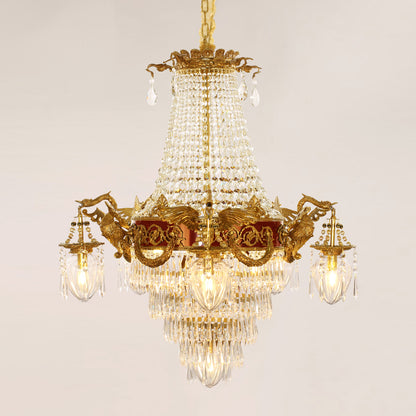 Victorian-style brass chandelier with red accents and intricate metalwork against black.