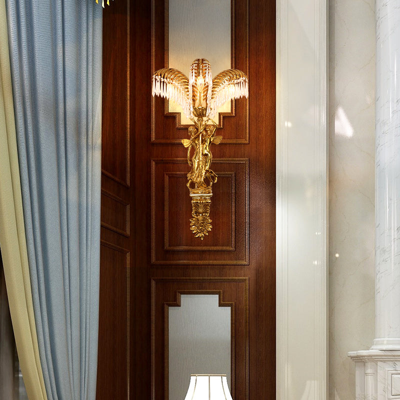 The French classical wall sconce installed on a rich brown wood-paneled wall between blue curtains and a white column.