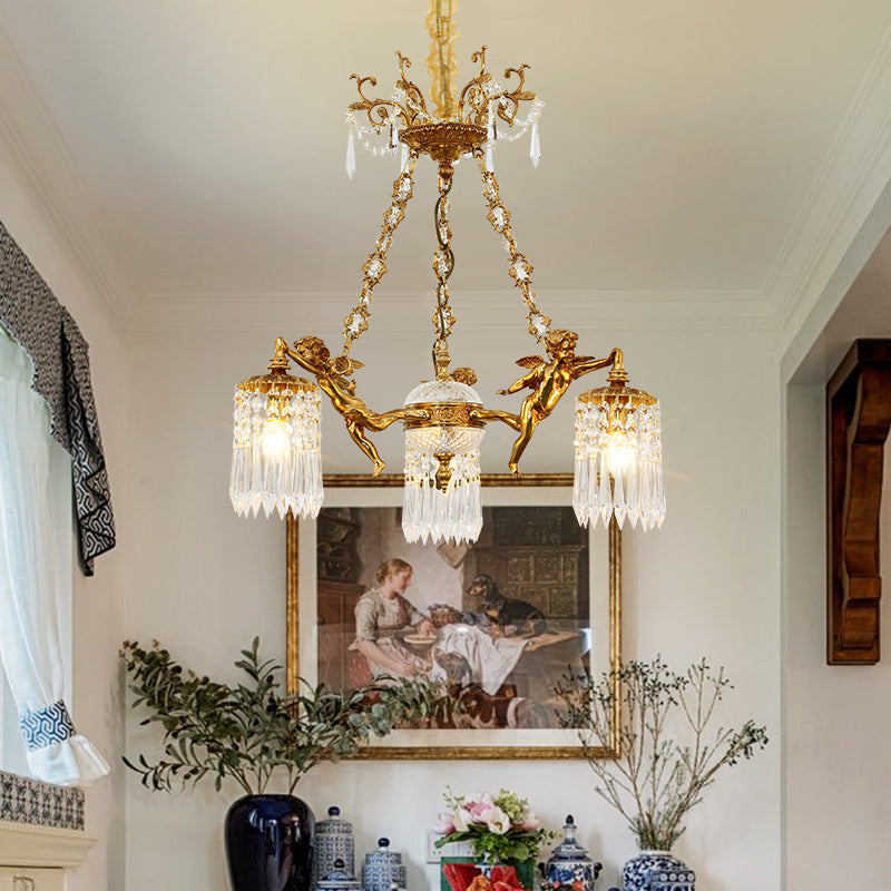 The luxury brass chandelier installed in an elegant room with a portrait painting and blue vase.