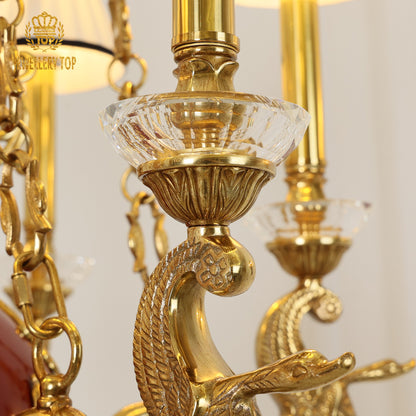 Macro detail of a curved brass arm with foliate holding a crystal cup.